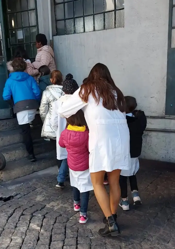 Fila de crianças com professoras a supervisionar